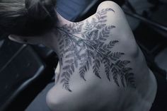 a woman with a tattoo on her back