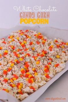 white chocolate candy corn popcorn with sprinkles in a baking pan on a table