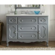 a bathroom vanity with two sinks and a mirror on the wall next to a wicker basket