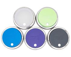 four different colored discs with holes in the middle and one on each side, set against a white background