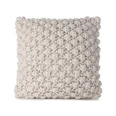 a white knitted pillow on a white background