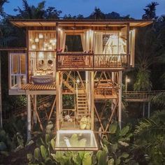 a tree house is lit up at night