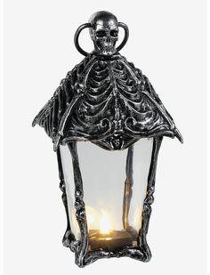 an old fashioned lantern with a skeleton on the top and light in the middle, against a white background