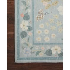 a blue and white rug with flowers on it