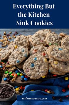 cookies with chocolate chips and m & m's on the side text reads everything but the kitchen sink cookies