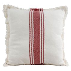 a red and white striped pillow with fringes on the bottom, in front of a white background