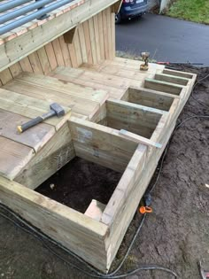 a wooden box with tools in it sitting on the ground