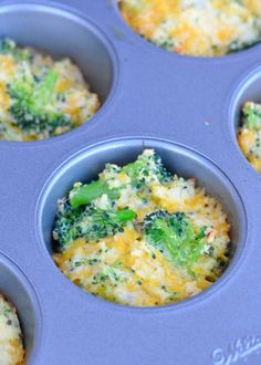 a muffin tin filled with cooked broccoli and cheesy toppings