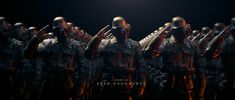 a group of soldiers stand in formation with their hands on their heads, and the light above them shines brightly