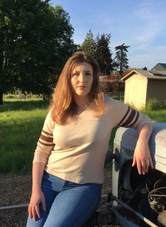 a woman sitting on the back of a truck