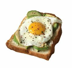 an egg and avocado toast on a white background with a black dot in the middle