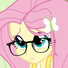 a pink pony with glasses and a flower in her hair is staring at the camera