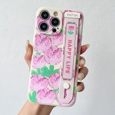 a person holding up a pink phone case with flowers painted on the front and sides