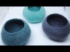 three yarn bowls sitting on top of a white surface