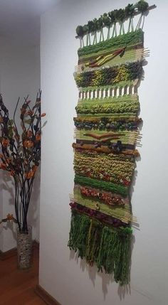 there is a wall hanging made out of vegetables