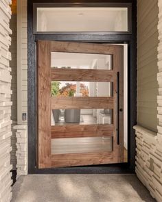 a wooden door is open on the side of a house