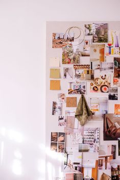 a white wall covered in pictures and magnets