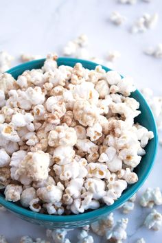 white chocolate churro popcorn in a blue bowl with text overlay that reads, white chocolate churro popcorn movie nights parties holidays