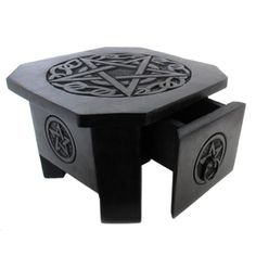 a small black table with an intricate design on it