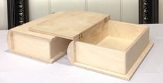 two wooden boxes sitting on top of a white table