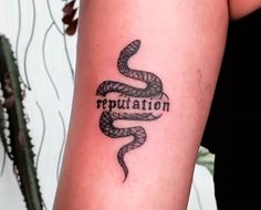 a woman's arm with a tattoo on it that says reputation and a snake