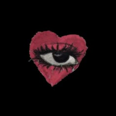 an eyeballed heart with long lashes on it's side is seen in the dark