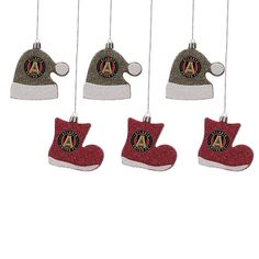 four christmas ornament hanging from strings with hats and booties on it's side