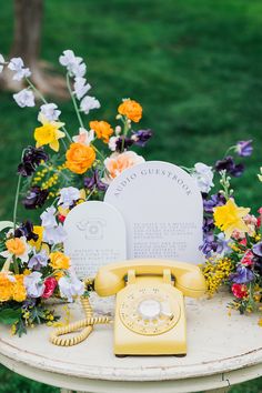 Yellow phone surrounded by colorful flowers Wedding Phone Booth, After The Tone, Guest Book Table Decor, Wedding Welcome Table, Wedding Phone, Wedding Pastel, Wedding Guest Book Table, Wedding Guest Table, Barr Mansion