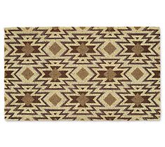 a brown and white rug with an abstract design on the front, in two different colors