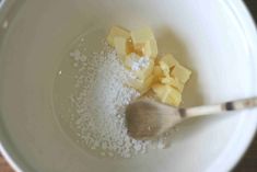 a white bowl filled with sugar and butter