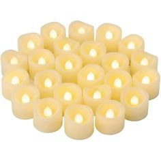 many white candles are arranged in the shape of a heart