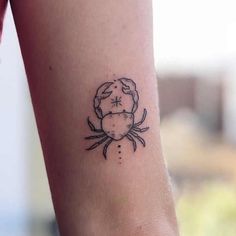 a small crab tattoo on the ankle