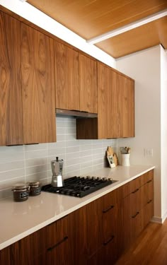 a kitchen with wooden cabinets and white counter tops