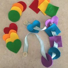 several pieces of felt are laid out on the floor to be made into heart ornaments