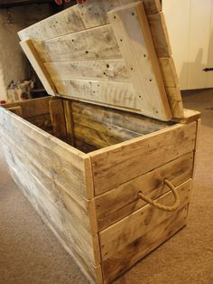 an open wooden box sitting on top of a carpeted floor next to a wall