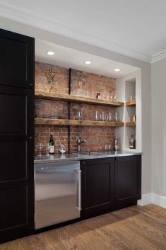 an image of a kitchen with brick wall and stainless steel dishwasher in it