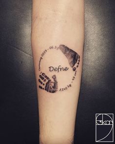 a hand and foot print with the words defre written in black ink on a person's arm