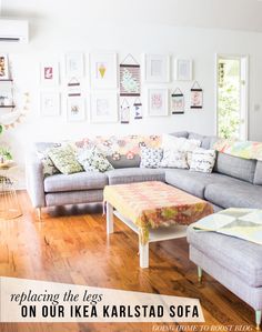 a living room filled with furniture and pictures on the wall