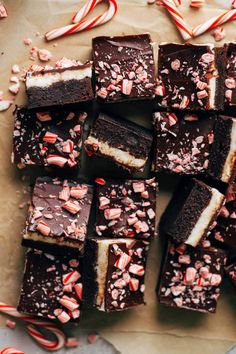 a pile of brownies with candy canes and peppermints on top,