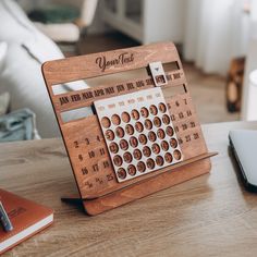 a wooden desk top with an old fashioned typewriter on it and a notebook next to it