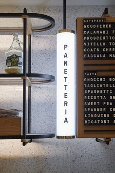 a display case with liquor bottles and other items on the wall behind it that reads panetteria