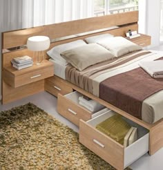 a bed with two drawers underneath it and a night stand next to the headboard