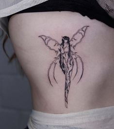 a woman's lower back with a bat tattoo on her side ribcage