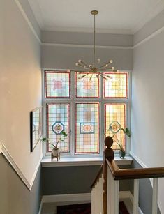 a staircase with stained glass windows and railing