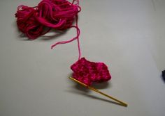 two crocheted objects are sitting on a table