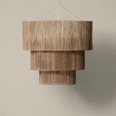 a light fixture hanging from a ceiling in a room with beige walls and flooring