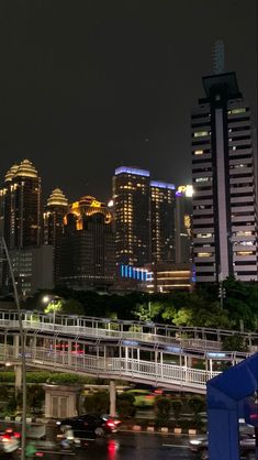 the city skyline is lit up at night