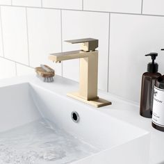 a bathroom sink with soap and lotion on it