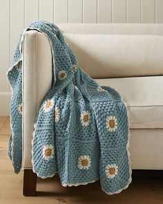 a crocheted blanket draped over a couch