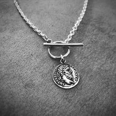 Dainty and slightly fractured ancient coin engraved with the Aequitas. In Ancient Rome, Aequitas was the divine personification of equity, fairness and symmetry.Handcrafted in 925 sterling silver, oxidised, and polished to a shiny rustic finish.Each pendant hangs on your choice of 925 sterling silver chain in the length of your choosing.Make your selection at checkout. (Please see care tips below)Length Options:14 inches 15 inches16 inches17 inches18 inches19 inches 20 inchesPendant Size: Height Silver Necklace Mens, Cross Necklace For Women, Jewelry For Him, Silver Necklace Simple, Silver Cross Necklace, Necklace Womens, Sterling Silver Cross Necklace, Necklace Mens, Silver Necklaces Women